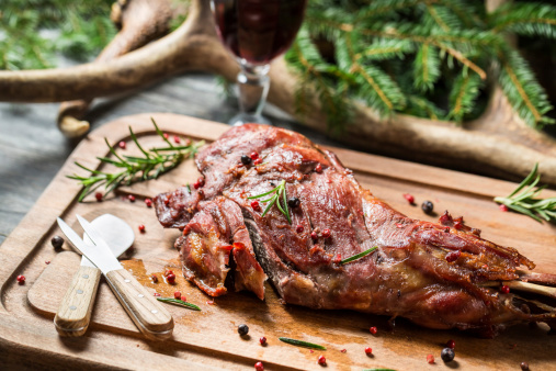 Closeup on chopping freshly baked venison.