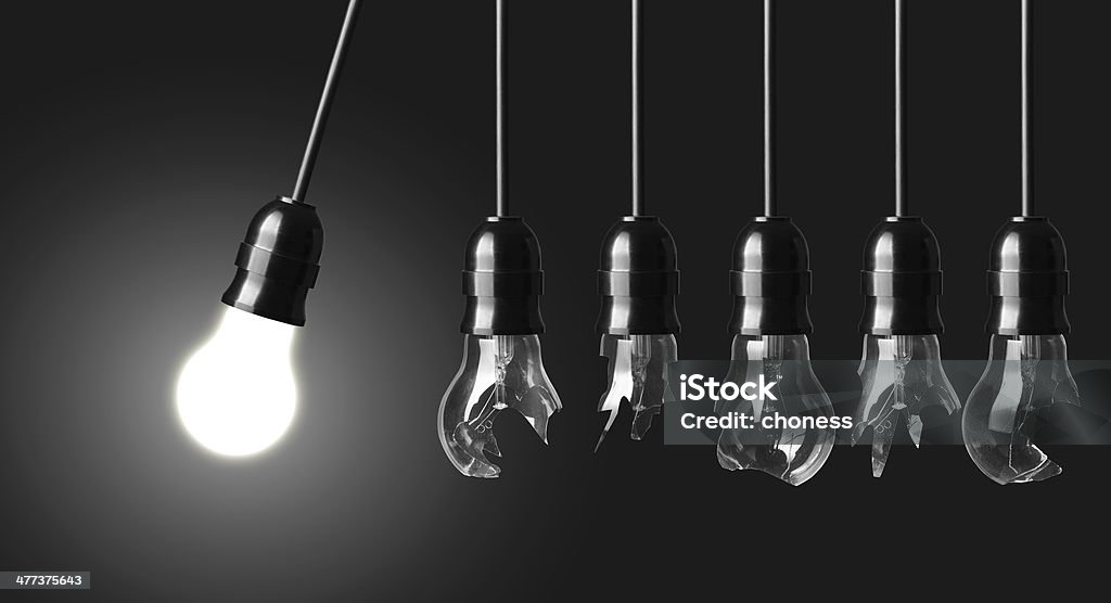 Perpetual motion Perpetual motion with broken light bulbs and glowing bulb Business Stock Photo