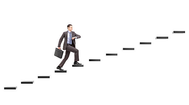 istock Young businessman with briefcase walking on steps towards the heights 477376475