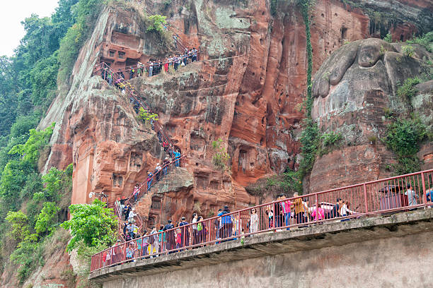 istock People Walking Past Worlds Tallest Buddha Statue in Leshan, China 477378134