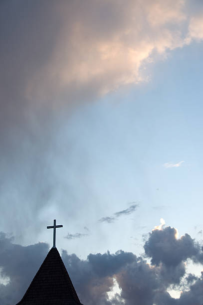 istock Church steeple with cross at sunset  Copy space 477378352