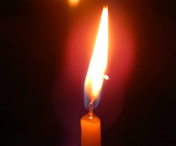 istock Burning candle on a black background 477380011