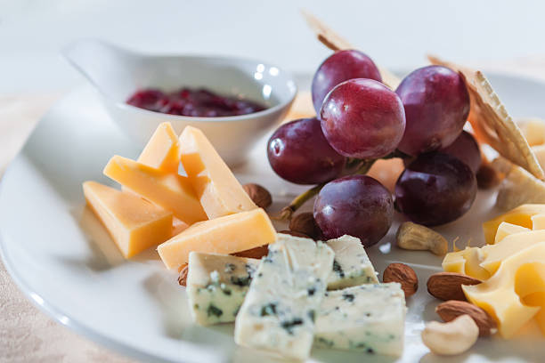 Slices of cheese with grapes and nuts