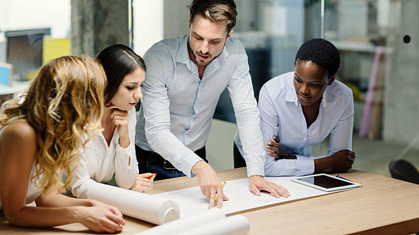 istock Multiethnic Team of architects reviewing reports in the office. 477385998