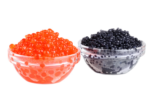 Black and red caviar in glass bowls on a white background