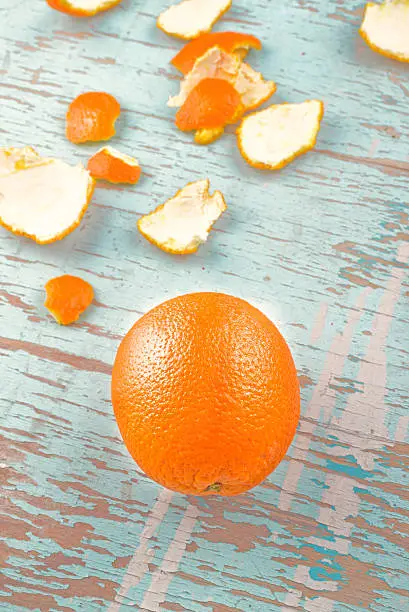 Fresh Ripe Sweet Orange Fruit and Peel on Rustic Grunge Blue Wood Background
