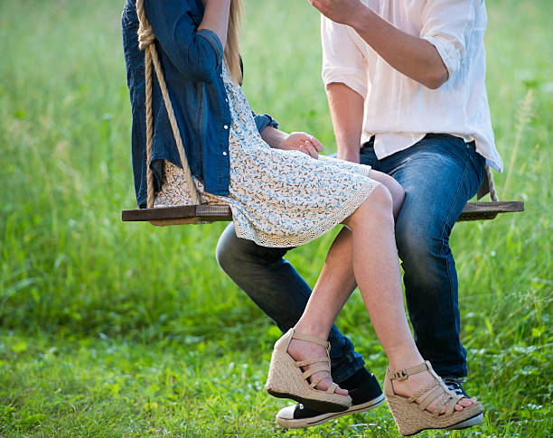 istock Young Couple On A Swing 477391450