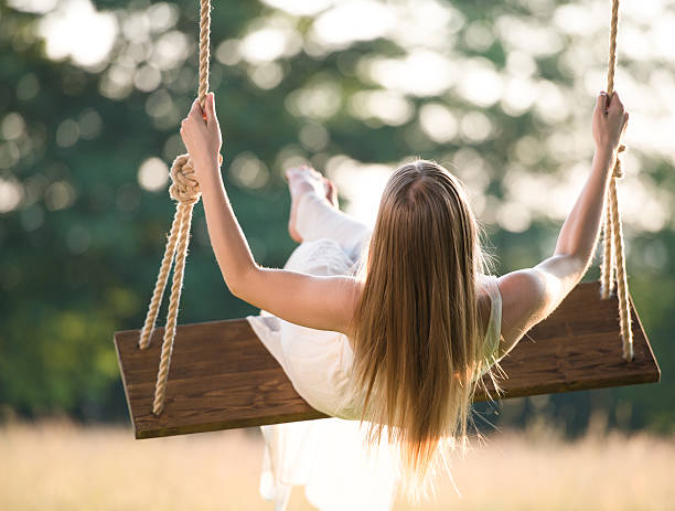 istock Young Women Swinging At Sunset 477391628