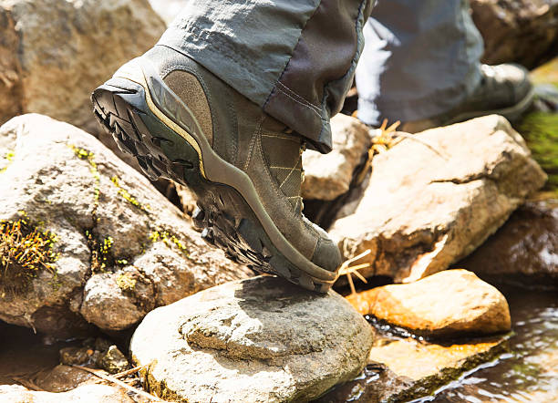 istock Creek Hiking with Mountain Boots Closeup 477392854