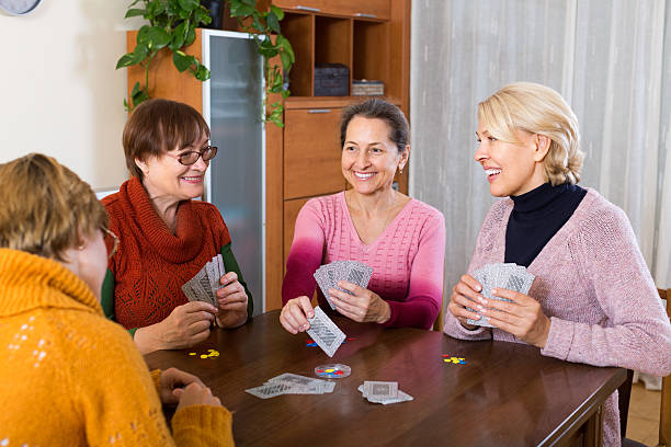 istock Female pensioners playing cards 477393096