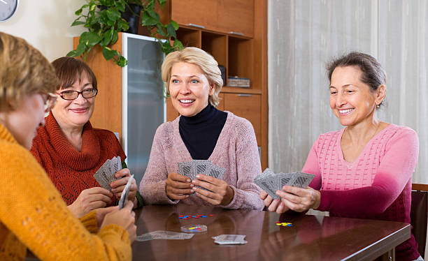 istock Female pensioners playing cards 477393098