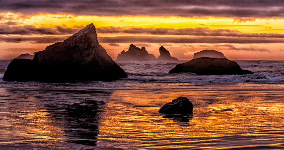 Red and gold skies light the water at Bandon Beach, Oregon