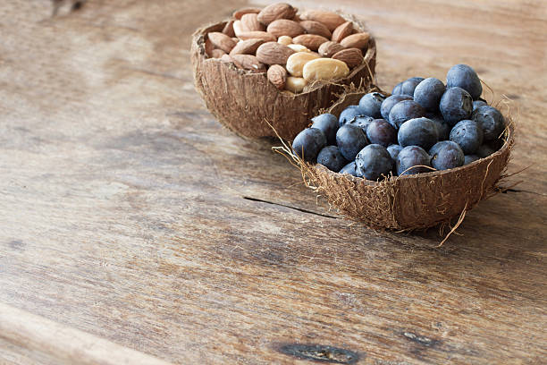 blueberries and almonds in the shell of a coconut