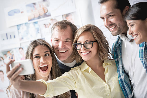 istock Creative people taking a selfie at the office 477397344