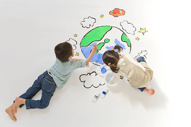 Children drawing a picture of earth stock photo