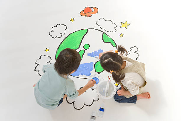 Children drawing a picture of earth stock photo