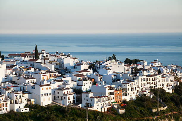 Townscape of Frigiliana, white houses village in Spain, sea background. stock photo