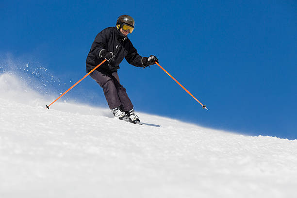 istock Male skier skiing at ski resort 477399624