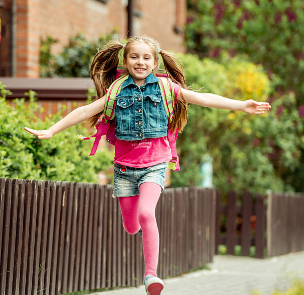 istock little girl  run from school 477399786