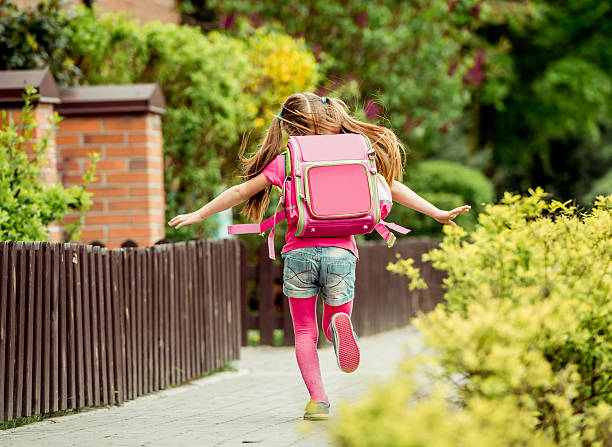 little girl  run to school little girl with a backpack run  to school. back view satchel stock pictures, royalty-free photos & images