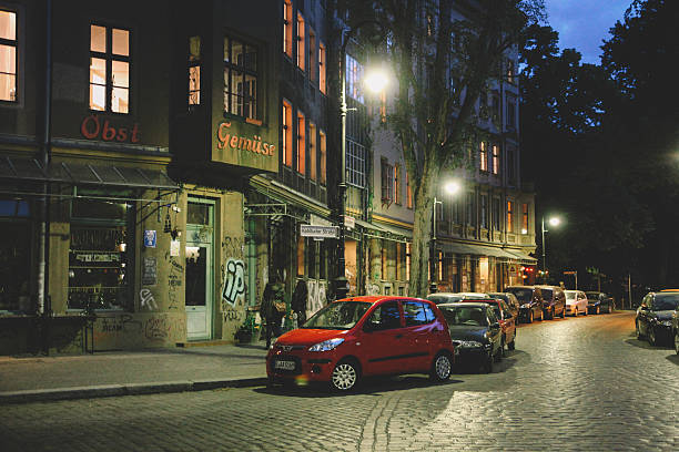Berlin, Germany - May 26, 2015: Graffiti decorated buildings and parked cars in Kreuzberg district of the former West Berlin, Germany. Taken late at night, near the Admiral bridge, a popular area filled with pubs and cafes. 