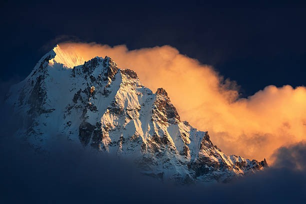 Himalaya's Fane Mountain seems like erupting with a clouds. Nepal, Kangchenjunga region, view of Ghabur Peak (6,044 m) from Kambachen village (4,090 m). kangchenjunga stock pictures, royalty-free photos & images