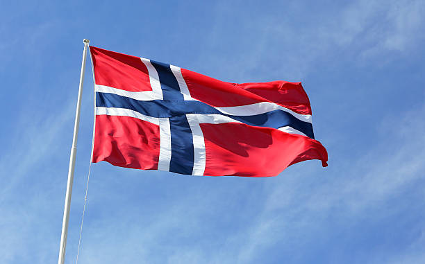 Norwegian flag Norwegian flag against blue sky. norwegian flag stock pictures, royalty-free photos & images