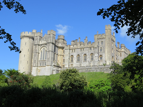 Arundel, UK - June 7th, 2015: Arundel Castle has overlooked the town since medieval times. The castle dates from the 11th century and has been modified several times to what can be seen today. Photograph taken from the roadside, ie not on castle grounds.