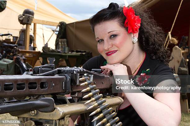 Pinup Leaning On Machine Gun Stock Photo - Download Image Now - 2015, Adult, Adults Only
