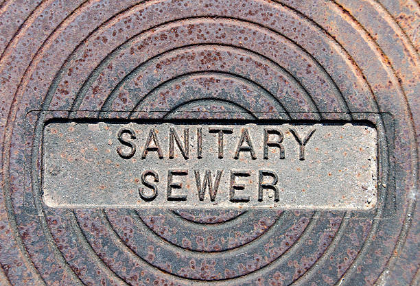 istock Sanitary Sewer Imprinted on Iron Cover for a Sewer System 477404116