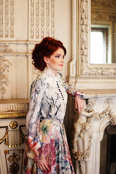 istock woman  posing next to the fireplace 477404414
