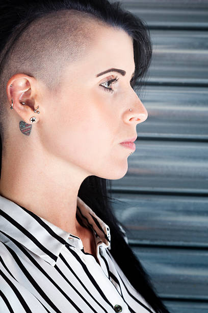 istock Woman With A Part-shaved Head And Tattoos 477408064
