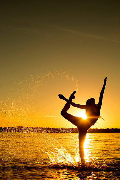 istock Beautiful girl dancing in the sunlight 477408212