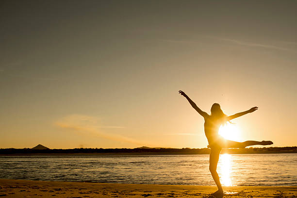 istock Girl ballet dancing on the beach 477408222
