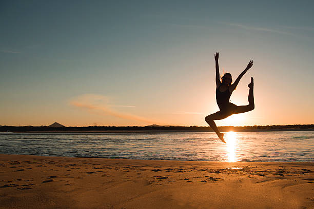 istock Young girl leaping up into the sky 477408224