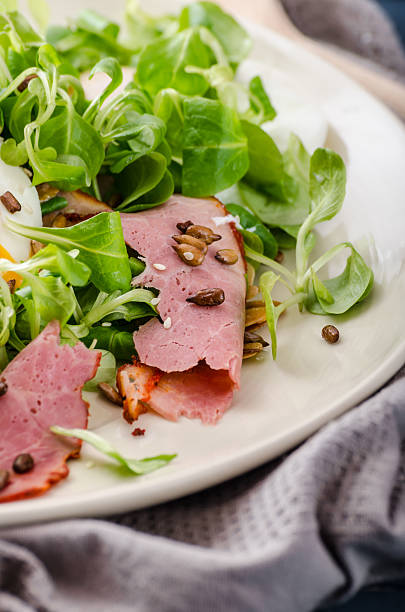 istock Lamb's lettuce salad with poached egg and nuts 477409948
