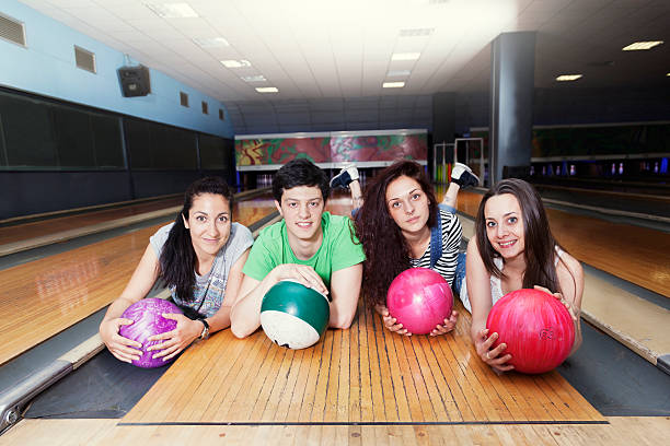 istock group of friends getting ready to play bowling 477410680