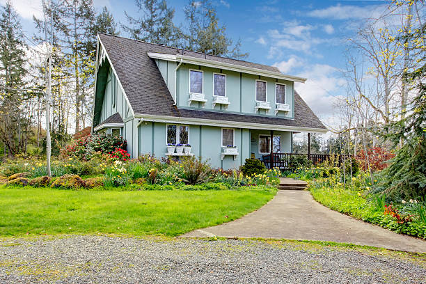 istock Beautiful farmhouse with open deck and charming flowerbed 477411693