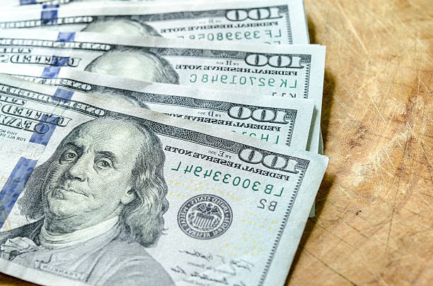 View backside  effect stack of one hundred dollar bills close-up stock photo