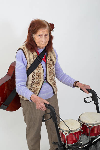 istock Elderly lady with rollator and musical instruments 477412212