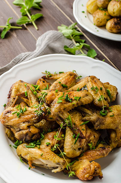 istock Roasted chicken wings with new potato 477413156