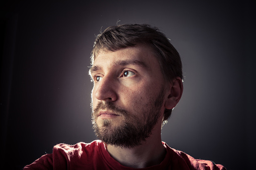 Tense face. Front view. Professional studio lighting.