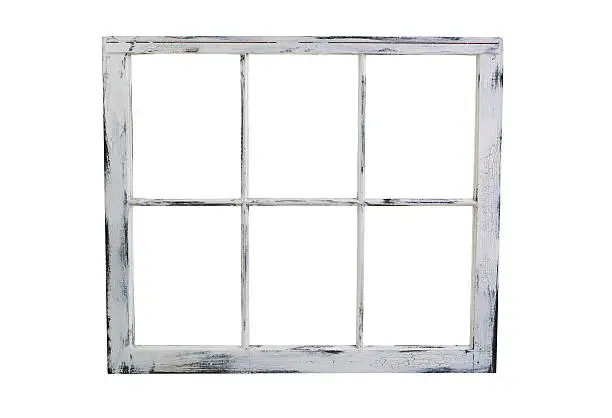 Vintage wooden window with fading white paint isolated on white background.