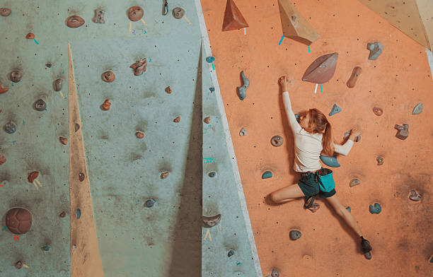 Young woman climbing in the gym