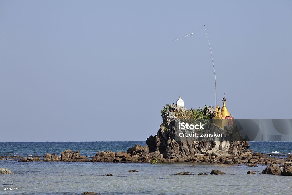 Buddhist pagodas on the beach Buddhist pagodas on top of rocks found on the beach of Ngwe Saung, west coast of Myanmar Asia Stock Photo
