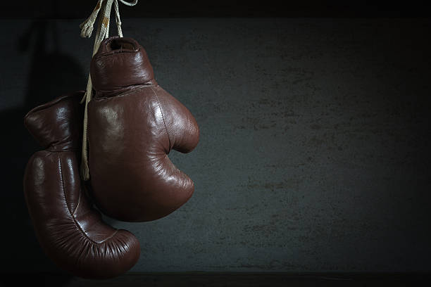 istock old used boxing Gloves, hanging before a dirty Wall 477415367