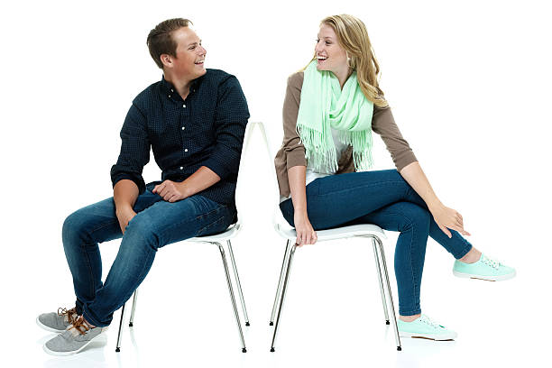 istock Happy couple sitting on chairs 477417634