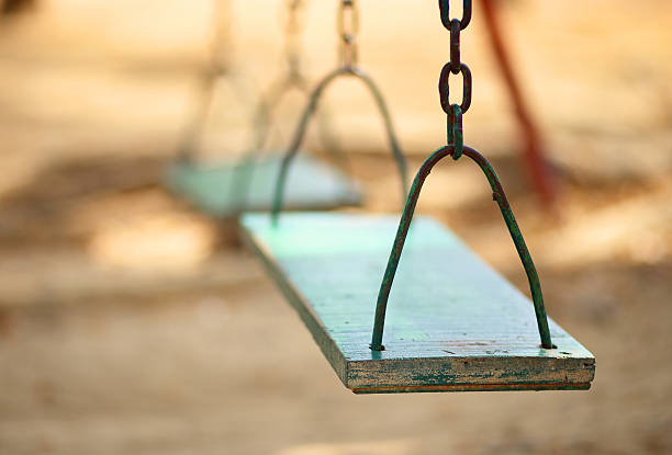 istock empty wood swing in the park 477418036