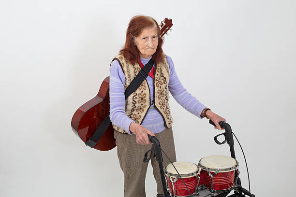 istock Elderly lady with rollator and musical instruments 477418670