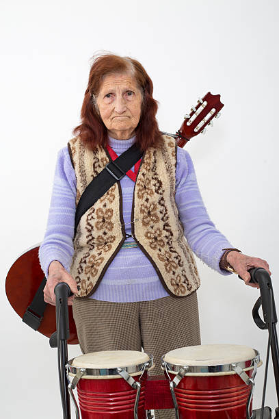 istock Elderly lady with rollator and musical instruments 477418672